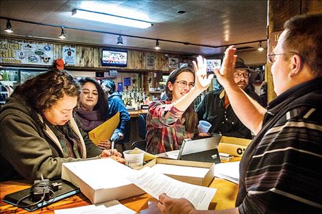 Brianna Ewert, cooperative development program manager for Lake County Community Development Corporation, high fives a newly signed on owner of the Ronan Cooperative Brewery.