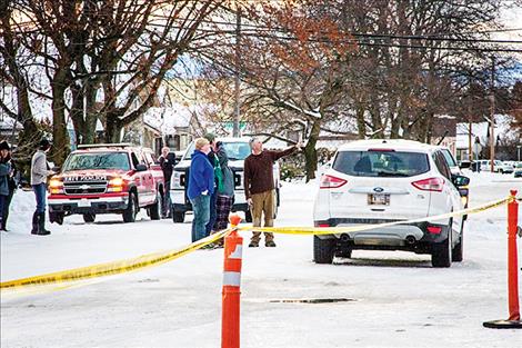 responders and members of the public look at the damage to the school.