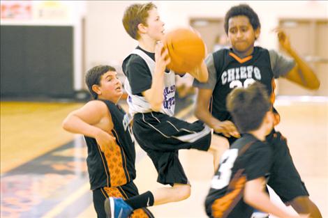 Landon Lynch, Kuba Detwiler and Randy Finley converge on an attacking Polson player during Ronan’s final fifth and sixth-grade game.