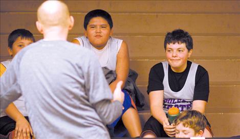 Polson players listen as coach Matt Dalbey gives a post-game talk to the team.