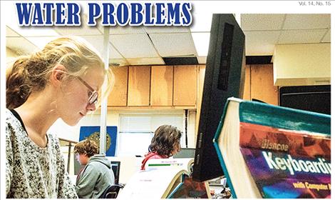 St. Ignatius School District students work on a typing lesson taught by teacher Joe Phillips. Melting snow damaged the ceiling in the corner of the room and almost ruined the printer.