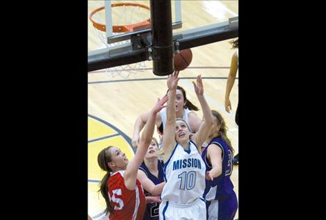 Mission senior Stephanie Lewandowski puts up a shot after grabbing the offensive rebound during the girls’ all-star game Friday night.