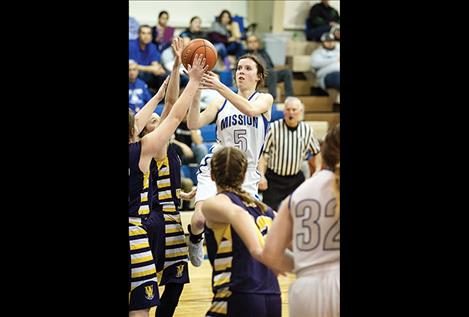 Lady Bulldogs Afton Brander shoots over defenders.