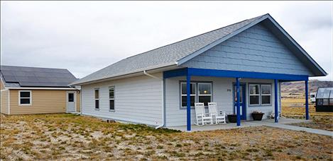 The exterior of a Whitehall home built through the National Affordable Housing Network is partially warmed by solar panels on the garage roof.