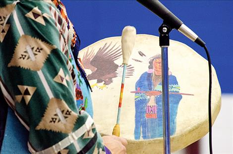 Spencer shares the sound of drum music with the children. 