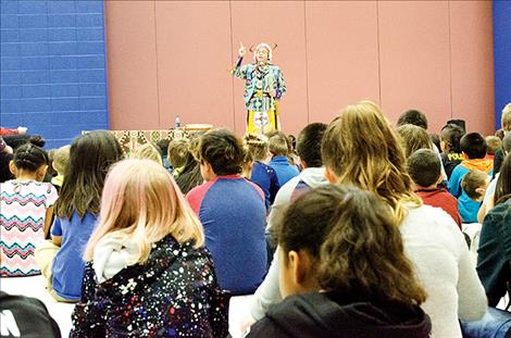  Storyteller James Spencer finishes the details on a story and then plays his flute. 