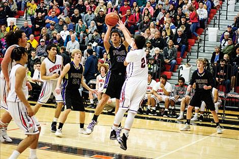 Polson Pirate Shade Main shoots a jumper over a defender.