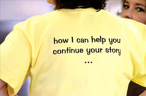 The back of the YLM's shirt encourages people to ask volunteers about resources to help prevent suicide. 