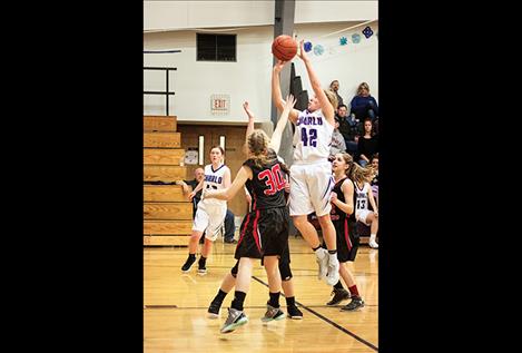 Charlo Lady Viking Liev Smith shoots a jumper over defenders.