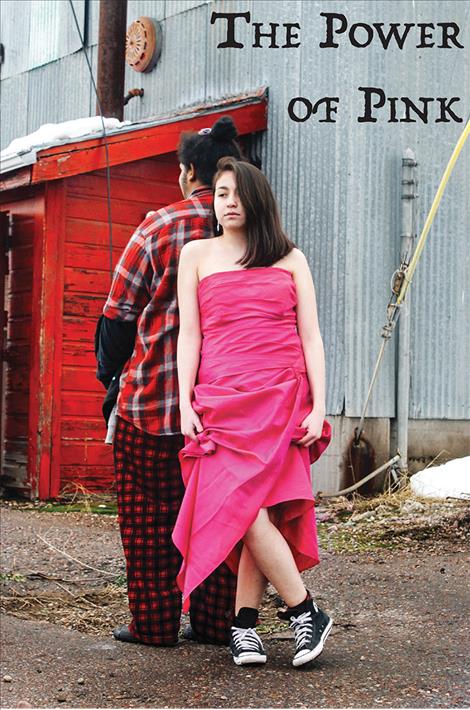 LeeAnn Yonkin wears a pink dress at the old lumber mill in Pablo while leaning on Zion Bolen. 