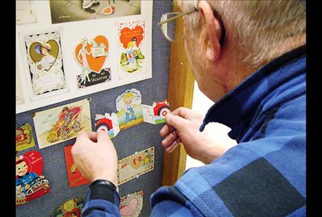 Gil Mangels looks at one of the 400 antique valentines on display at Miracle of America Museum. 