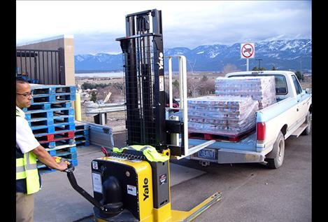 Aaron Pinkston loads a truck with soup last week. Some 6,000 cans of tomato and chicken noodle soup were purchased by Glacier View Seventh-day Adventist Church for distribution to food banks in Ronan and Polson. 