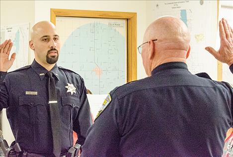 Ronan Police Chief Ken Weaver swears in Officer Joel Diaz. 