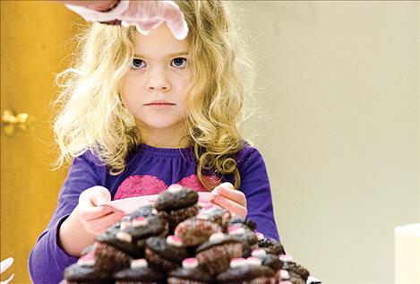 Kay Lynne  Frey, 4, waits for a chocolate cupcake.