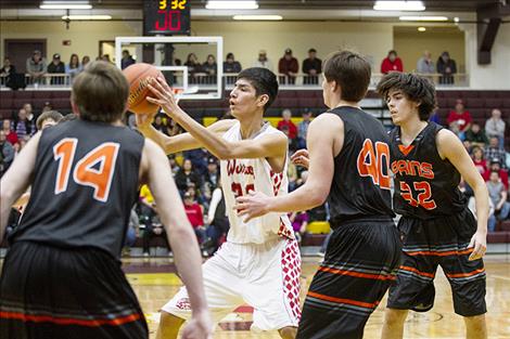 Arlee Warrior Isaac Fisher dishes the ball off to a teammate.