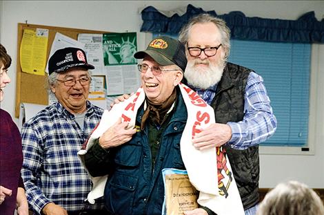 Drew Hendrickson receives a plaque and a banner for his service.