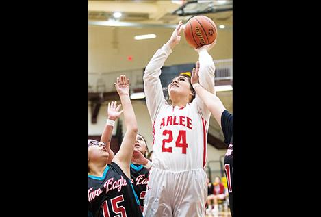 Scarlet Alyssia Vanderburg battles through defenders for two points.