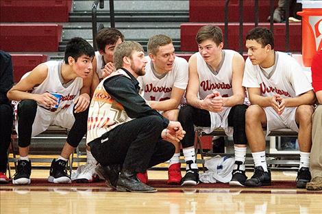 : Warriors' coach Zanen Pitts talks with his bench in the waning moments of the fourth quarter.