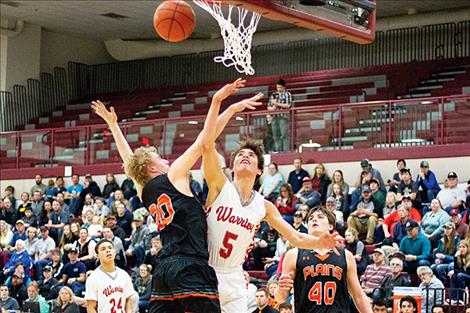 Arlee Warrior Lane Johnson battles a defender under the basket.