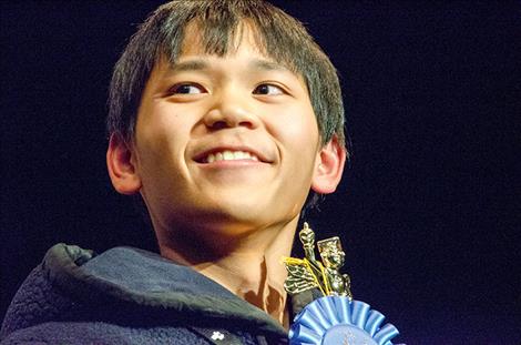 Eighth-grader John Paca of Ronan holds his winning trophy for the Lake County Spelling Bee on Tuesday.