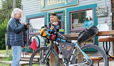 Kathy Schoendoerfer and Randy Neil chat in front of the Schoendoerfer’s store, Blackfoot Angler. Neil is riding in his third Tour Divide.