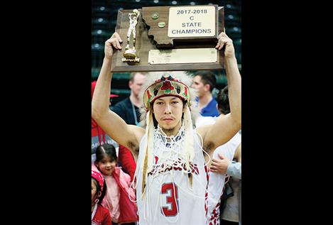 Warrior Will Mesteth holds up the championship trophy. 