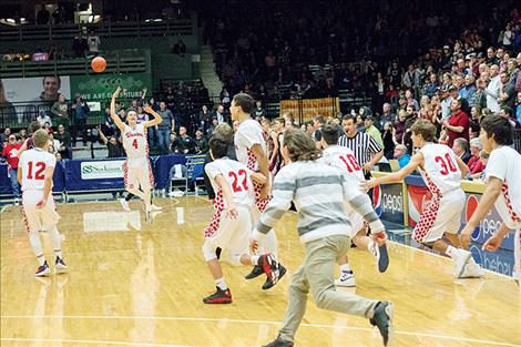 The Warriors’ bench races out onto the court in celebration.