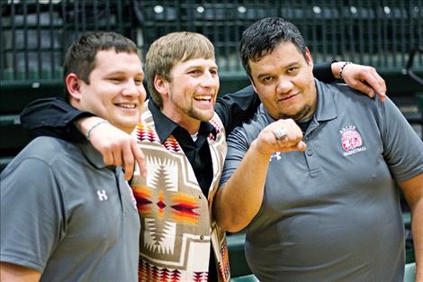 Warrior coaching staff shares in the celebration.