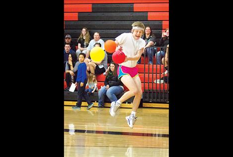 Bridger Wenzel is pelted by colorful orbs during Friday's dodgeball fundraiser to benefit the Ronan High School spring sports program.