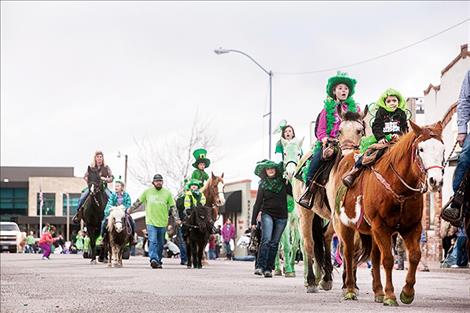 Horses and ponies, including a few green equines, join parade  participants.