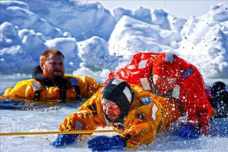 Chief Cliff volunteer firefighters practice ice rescue techniques in the Lake Mary Ronan area.