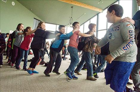 Boys & Girls Club kids dance to the beat in a conga line. 