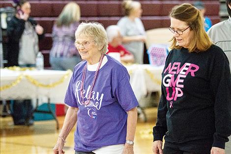 Friends Bessie Argo and  Betty Sieges share some smiles during the survivor lap.