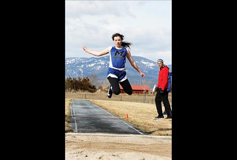 St. Ignatius’ Afton Brander heads to the sand on her final leap of the triple jump. She took second in the event with a jump of 32 feet 8.5 inches.