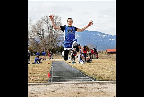 Mission Bulldog Flint McPherson flies through the air in the Long Jump at the Jim Johnson Invitation at Frenchtown Thursday, March 29.