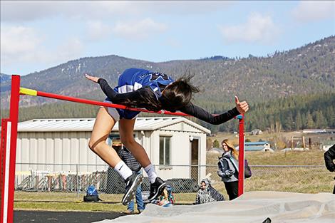 Karolyna Buck heads over the bar in the high jump. She took second place and auto qualified for state by clearing 5 feet.