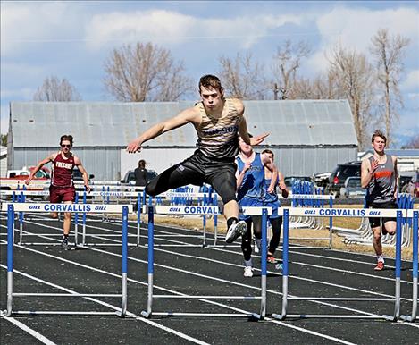 Polson’s Colton Cote clears the final hurdle of the 300-meter hurdles at the Gene Hughes Invitational on March 24. Cote won the event with a time of 50.02 seconds. 