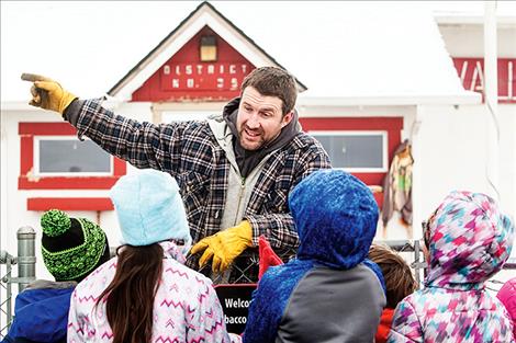 Justin Fisher entertains eager hunters at Valley View school before they break down the front gate.   