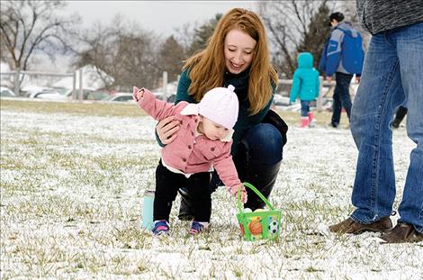 Children find  eggs on the  snowy fields  during the  St. Ignatius  Easter Egg  Hunt on  Saturday. 
