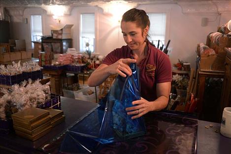 Heidi Beck-Heser wraps an assortment of candy at The Sweet Palace in Philipsburg. Beck-Heser helped her mother Shirley Beck start the business in 1997 and now manages the store.