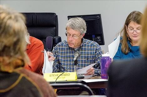 Chairman Steve Rosso looks over documents during the meeting.