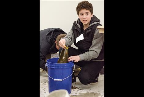 Daxter Stone, seventh grader, learns to clean a boot to  prevent contaminated water from getting into any other body of water.