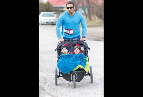 Jaxon, Jade and dad Jason Fuhrmann cross the finish line.