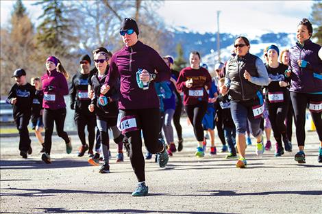 Runners sprint from the start line on the cilly but sunny Saturday.