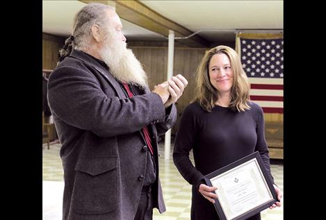 Mason Anthony Porrazzo presents a certificate of apprectiation to Julie Sisler of the Polson Fire Department. 