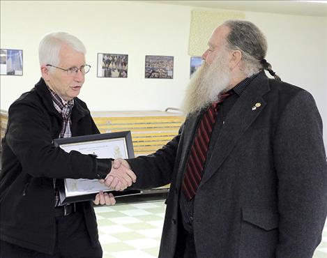 Mason Anthony Porrazzo presents a certificate of apprectiation to Matt Dougherty of the Polson Rural Fire District.