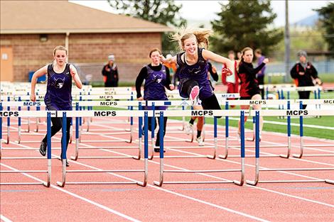 Charlo Lady Viking Carlee Fryberger is all smiles as she, along with running mates Kaitlin Cox and Allie Delaney, finish first, second and third in the 100-meter hurdles.