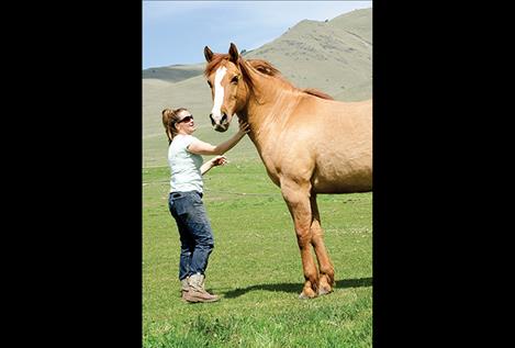 Danyea Logan-Young spends time with a horse she rescued.  