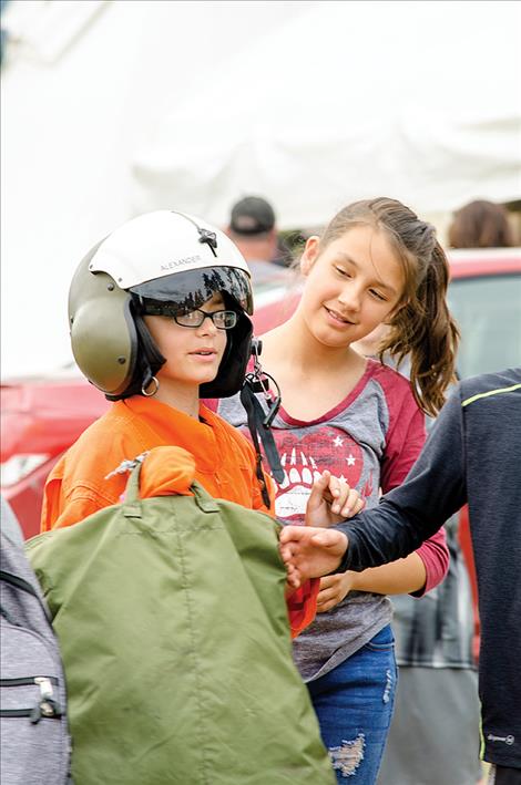 Gordon Stewart, 11, tries on a pilot's gear, utilized in water measuring. 