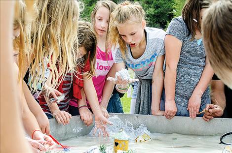 At the 32nd annual River Honoring, children use sand to see how rivers erode.